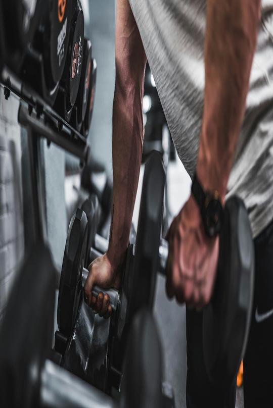 A dumbbell curl shot in low light