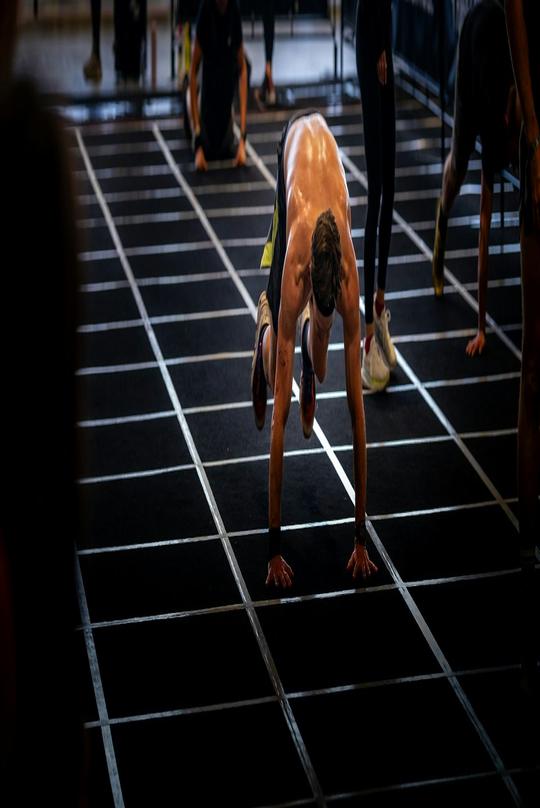 A burpee broad jump down a marked lane