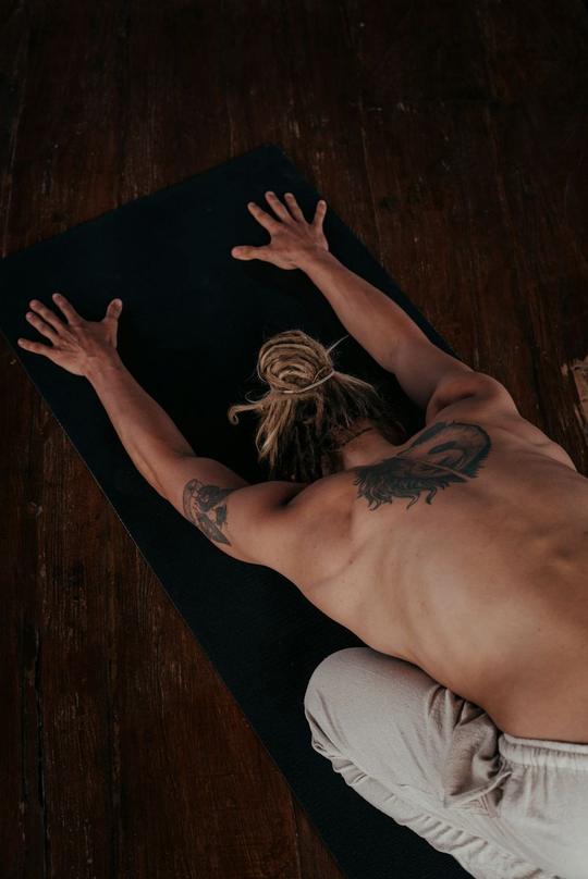 An extended reach on a mat, shot from above